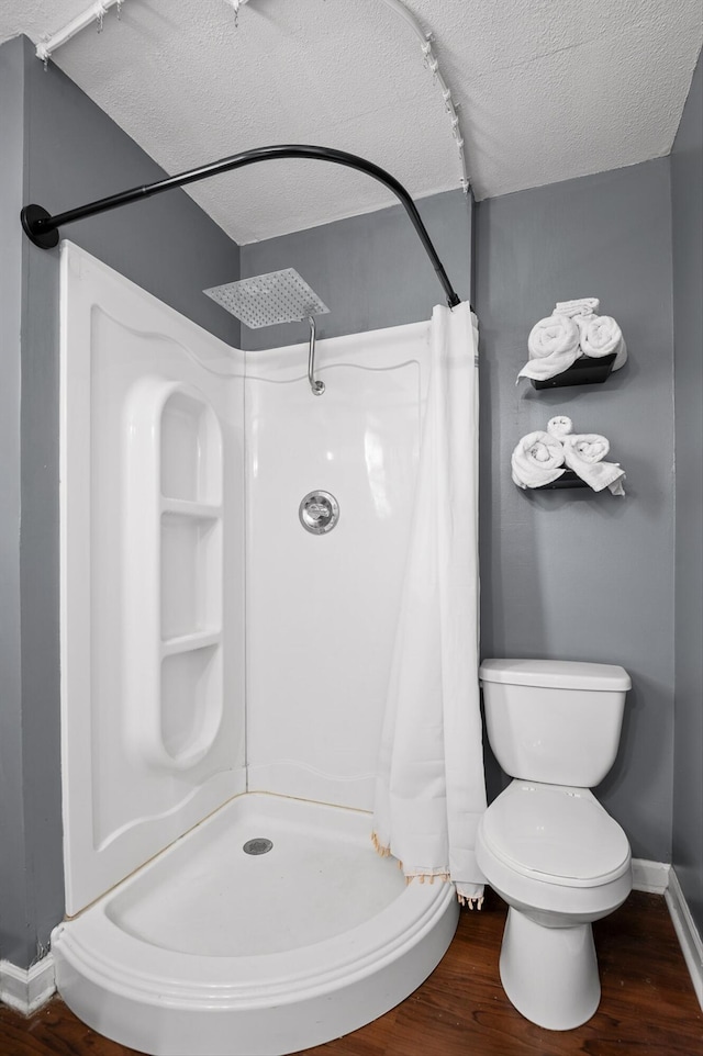 411 Meadow Green Dr, Ringgold, GA 30736 - bathroom featuring a textured ceiling, a shower stall, and wood finished floors