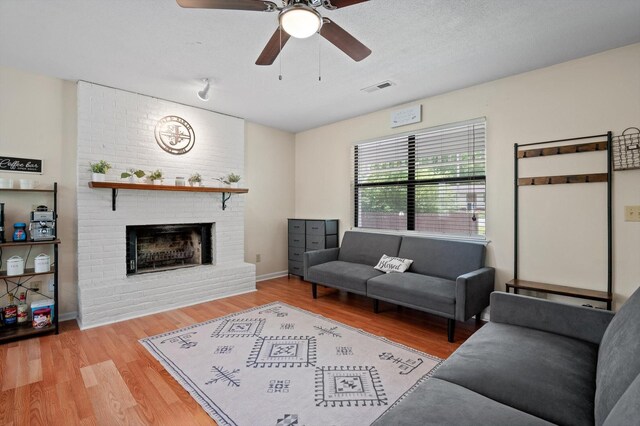 411 Meadow Green Dr, Ringgold, GA 30736 - living area featuring a fireplace, wood finished floors, and a ceiling fan