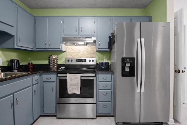 411 Meadow Green Dr, Ringgold, GA 30736 - kitchen with appliances with stainless steel finishes, exhaust hood, dark countertops, and light tile patterned floors