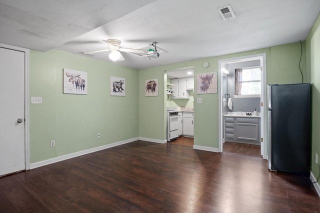 411 Meadow Green Dr, Ringgold, GA 30736 - unfurnished bedroom with freestanding refrigerator, dark wood-style floors, connected bathroom, and ceiling fan