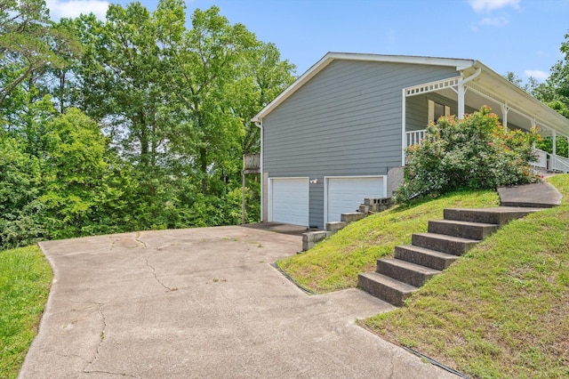 411 Meadow Green Dr, Ringgold, GA 30736 - view of side of home featuring an attached garage, driveway, stairway, and a porch