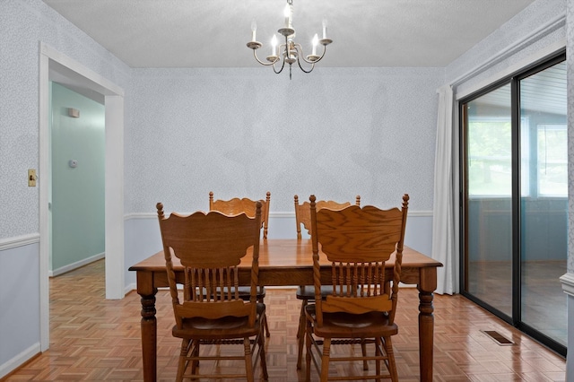 7622 Cove Ridge Dr, Hixson, TN 37343 - dining room featuring a chandelier and a textured ceiling