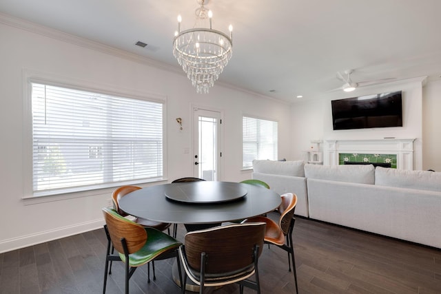 7183 Tailgate Loop, Ooltewah, TN 37363 - dining room featuring a chandelier, ornamental molding, and dark wood-type flooring