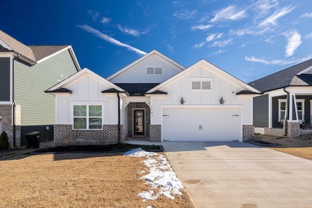 7183 Tailgate Loop, Ooltewah, TN 37363 - view of front facade with board and batten siding, driveway, brick siding, and a garage