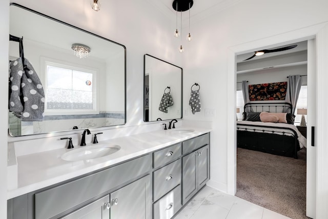 7183 Tailgate Loop, Ooltewah, TN 37363 - ensuite bathroom with healthy amount of natural light, double vanity, ornamental molding, and marble look tiles