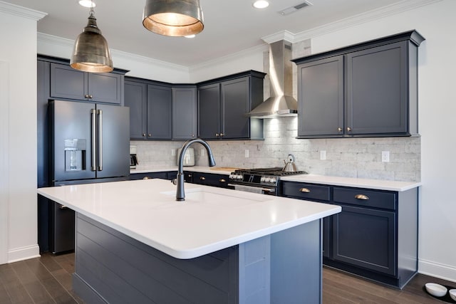 7183 Tailgate Loop, Ooltewah, TN 37363 - kitchen featuring wall chimney range hood, dark wood finished floors, stainless steel appliances, ornamental molding, and an island with sink