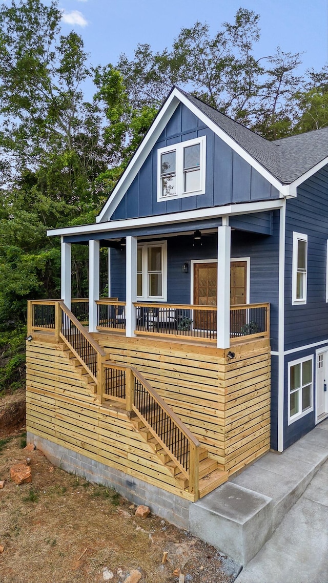 5509 Alabama Ave, Chattanooga, TN 37409 - view of front of property with stairway, covered porch, board and batten siding, and roof with shingles