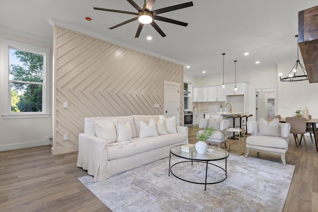 5509 Alabama Ave, Chattanooga, TN 37409 - living room featuring ceiling fan, crown molding, recessed lighting, light wood finished floors, and a chandelier