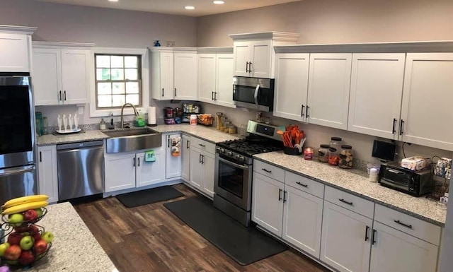 1241 Emerson Cir, Hopkinsville, KY 42240 - kitchen with stainless steel appliances, recessed lighting, white cabinetry, dark wood finished floors, and light stone counters