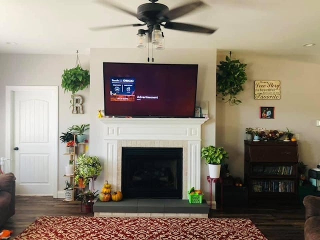 1241 Emerson Cir, Hopkinsville, KY 42240 - living area with wood finished floors, a ceiling fan, and a tile fireplace