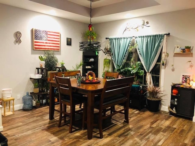 1241 Emerson Cir, Hopkinsville, KY 42240 - dining space featuring wood finished floors, a raised ceiling, and a chandelier