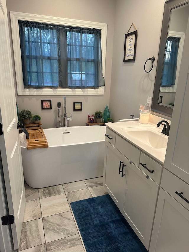 1241 Emerson Cir, Hopkinsville, KY 42240 - bathroom featuring a freestanding bath, vanity, and marble look tile flooring