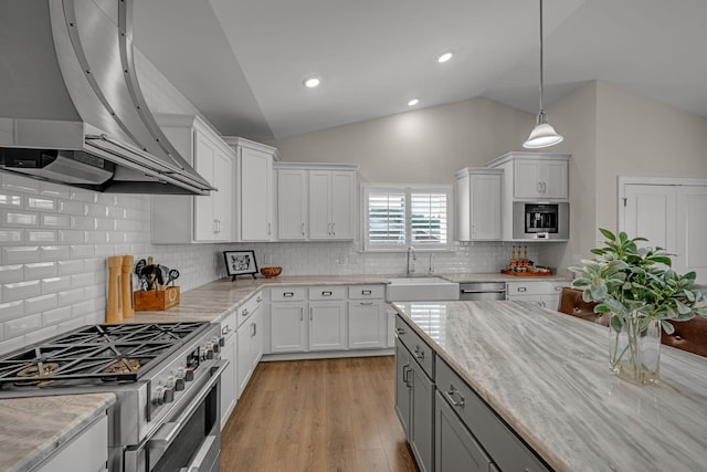 7192 Winfrey Dr, Fairview, TN 37062 - kitchen featuring wall chimney exhaust hood, stainless steel appliances, white cabinetry, lofted ceiling, and gray cabinets