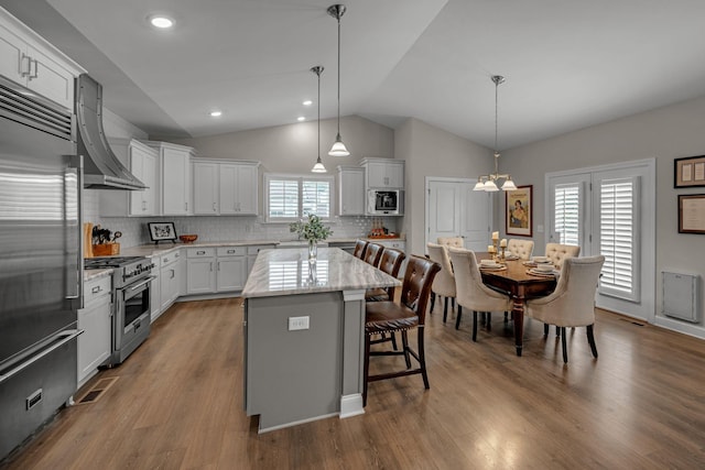 7192 Winfrey Dr, Fairview, TN 37062 - kitchen featuring high quality appliances, lofted ceiling, a kitchen breakfast bar, a center island, and ventilation hood