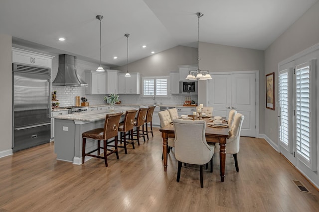 7192 Winfrey Dr, Fairview, TN 37062 - dining space with lofted ceiling, a chandelier, light wood finished floors, and recessed lighting