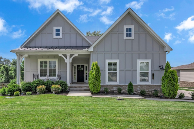 7192 Winfrey Dr, Fairview, TN 37062 - view of front of home featuring board and batten siding, a porch, a front yard, a standing seam roof, and brick siding