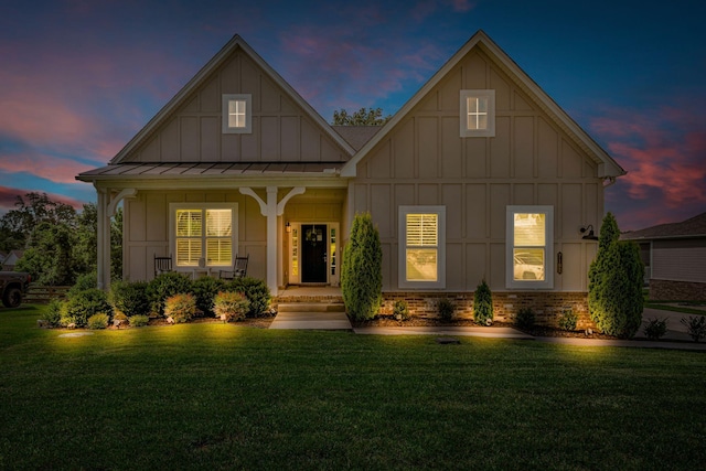 7192 Winfrey Dr, Fairview, TN 37062 - view of front of house with board and batten siding, a front lawn, a porch, and a standing seam roof