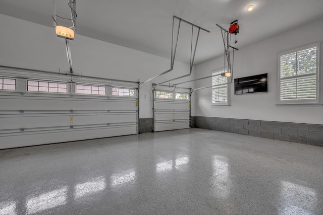 7192 Winfrey Dr, Fairview, TN 37062 - garage featuring a garage door opener and wainscoting