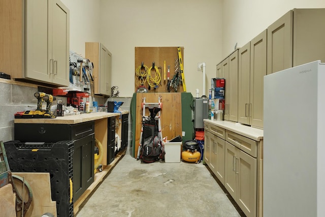 9208 Windstone Dr, Ooltewah, TN 37363 - kitchen with freestanding refrigerator, unfinished concrete floors, and light countertops
