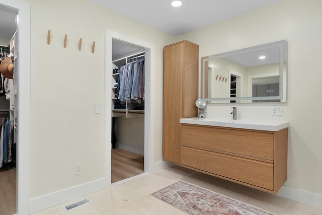 9208 Windstone Dr, Ooltewah, TN 37363 - bathroom featuring vanity, a walk in closet, and recessed lighting