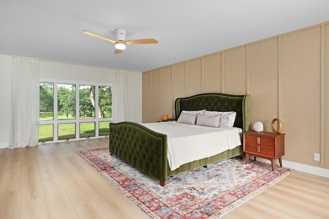 9208 Windstone Dr, Ooltewah, TN 37363 - bedroom featuring a decorative wall, light wood-type flooring, and a ceiling fan