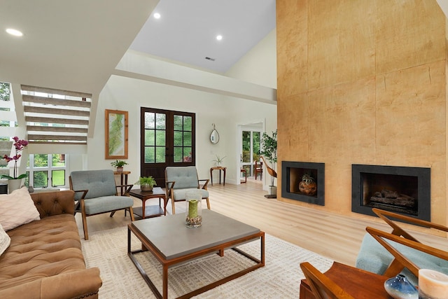 9208 Windstone Dr, Ooltewah, TN 37363 - living room featuring a towering ceiling, light wood finished floors, a fireplace, and recessed lighting