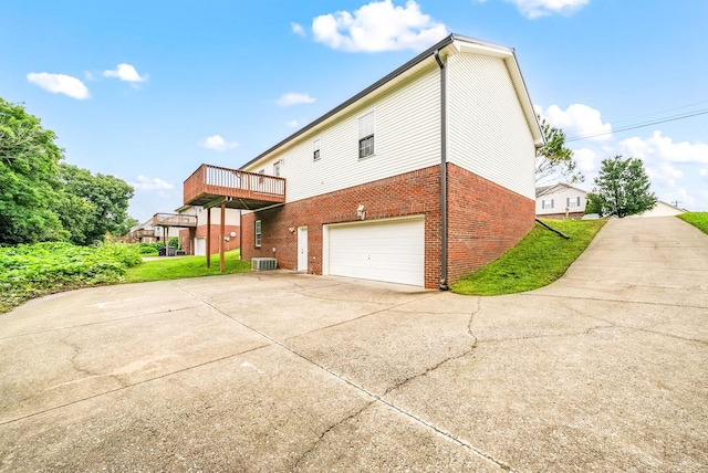 3366 N Henderson Way, Clarksville, TN 37042 - view of home's exterior with brick siding, a garage, concrete driveway, and a wooden deck
