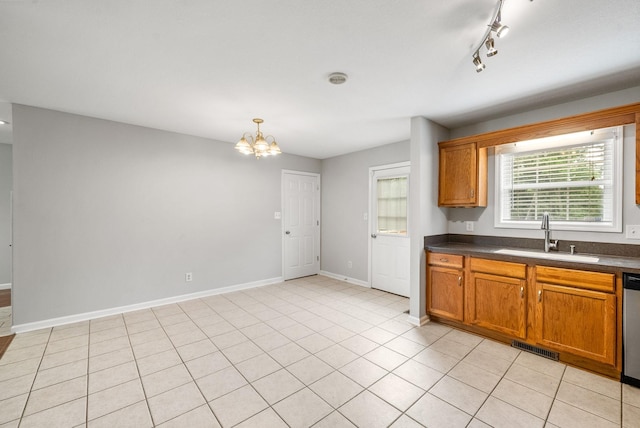 3366 N Henderson Way, Clarksville, TN 37042 - kitchen featuring dark countertops, stainless steel dishwasher, a chandelier, brown cabinetry, and pendant lighting