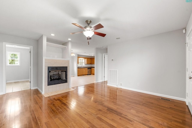 3366 N Henderson Way, Clarksville, TN 37042 - unfurnished living room featuring ceiling fan, light wood finished floors, a tiled fireplace, and recessed lighting