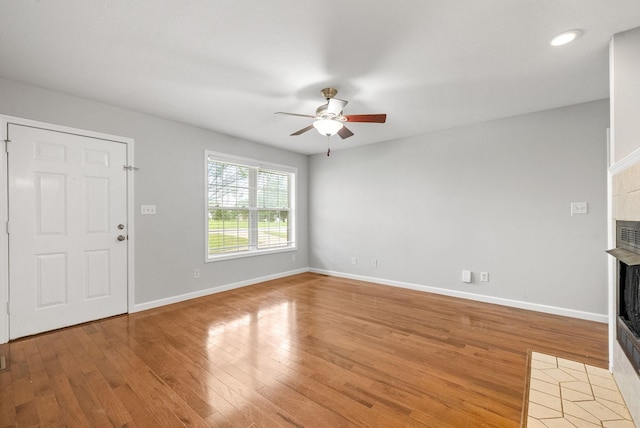 3366 N Henderson Way, Clarksville, TN 37042 - unfurnished living room with a tiled fireplace, ceiling fan, light wood finished floors, and recessed lighting