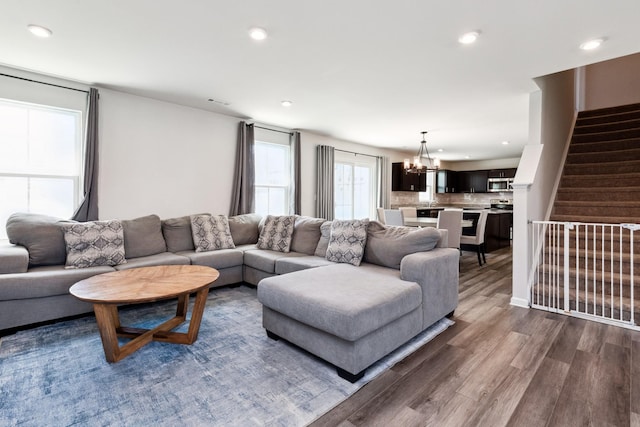 1802 Quail Run Way, Spring Hill, TN 37174 - living room featuring dark wood-style floors, recessed lighting, a chandelier, and stairs