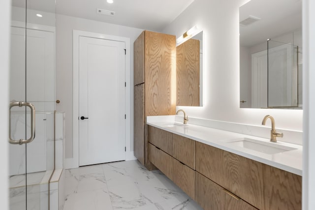 321 31st Ave N Unit B1 B, Nashville, TN 37203 - bathroom with double vanity, a shower stall, marble look tile flooring, and recessed lighting