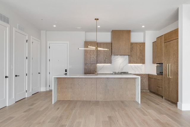 321 31st Ave N Unit B1 B, Nashville, TN 37203 - kitchen featuring light wood-type flooring, modern cabinets, brown cabinets, and recessed lighting