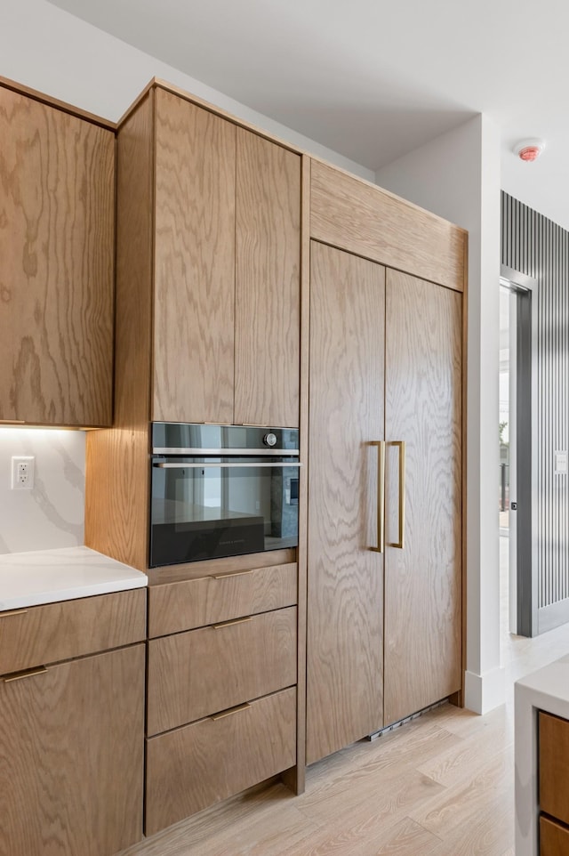 321 31st Ave N Unit B1 B, Nashville, TN 37203 - kitchen featuring oven, light wood-style flooring, light countertops, and light brown cabinetry