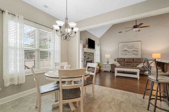1640 Drayton Dr, Murfreesboro, TN 37130 - dining area with a chandelier, ceiling fan, vaulted ceiling, and a stone fireplace
