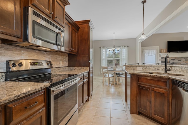 1640 Drayton Dr, Murfreesboro, TN 37130 - kitchen with stainless steel appliances, tasteful backsplash, light tile patterned floors, a chandelier, and decorative light fixtures