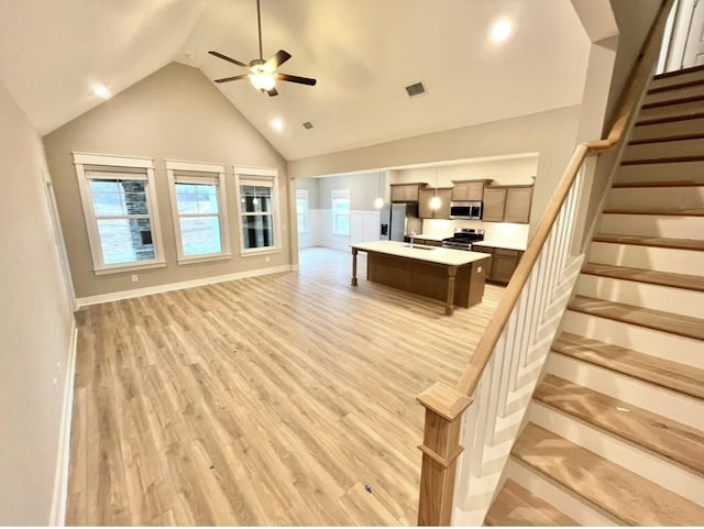 2618 Unitas Dr, Murfreesboro, TN 37129 - living area featuring light wood-style floors, a ceiling fan, lofted ceiling, and stairs
