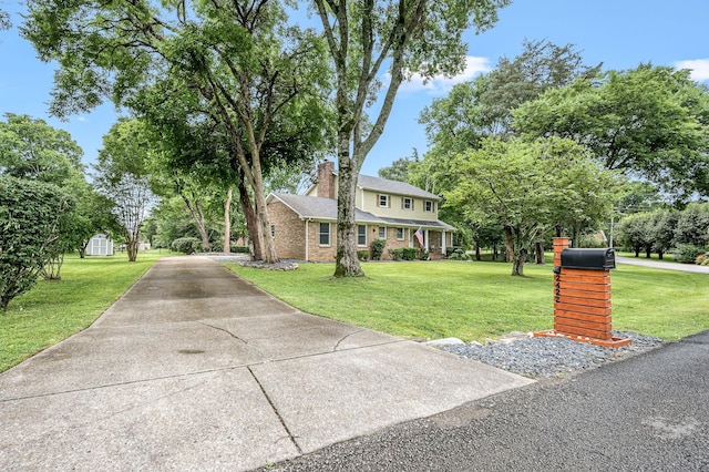 2422 Choctaw Trce, Murfreesboro, TN 37129 - view of front of home with a front lawn, driveway, a chimney, and brick siding