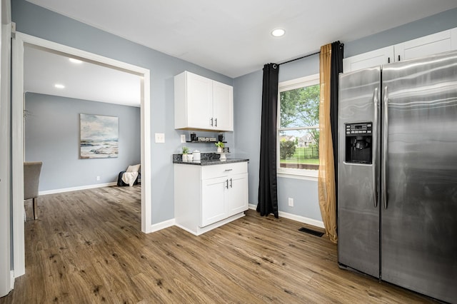 2422 Choctaw Trce, Murfreesboro, TN 37129 - kitchen with stainless steel fridge with ice dispenser, wood finished floors, white cabinetry, recessed lighting, and dark stone counters