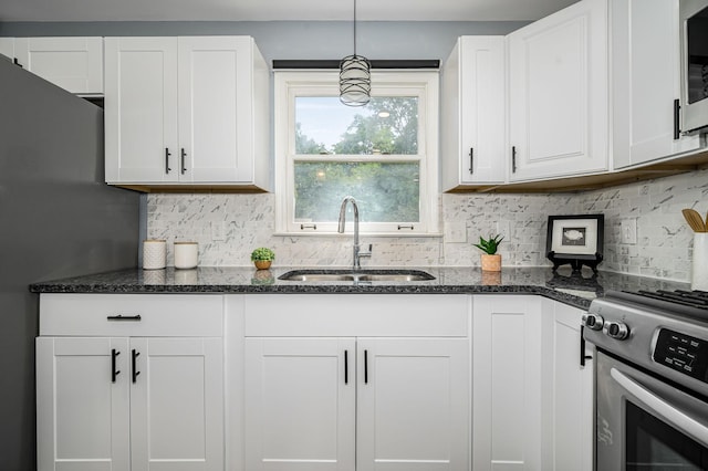 2422 Choctaw Trce, Murfreesboro, TN 37129 - kitchen with appliances with stainless steel finishes, white cabinetry, decorative backsplash, and dark stone countertops