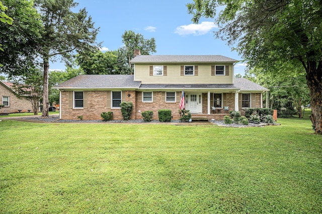 2422 Choctaw Trce, Murfreesboro, TN 37129 - traditional home featuring a chimney, a porch, a front yard, and brick siding