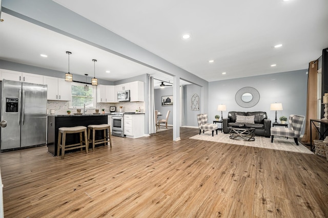 2422 Choctaw Trce, Murfreesboro, TN 37129 - living room featuring light wood-style floors, recessed lighting, and a ceiling fan
