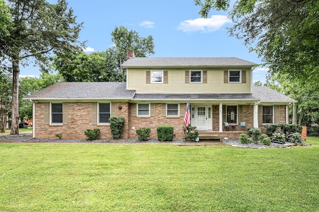 2422 Choctaw Trce, Murfreesboro, TN 37129 - traditional home with a chimney, a front yard, brick siding, and covered porch