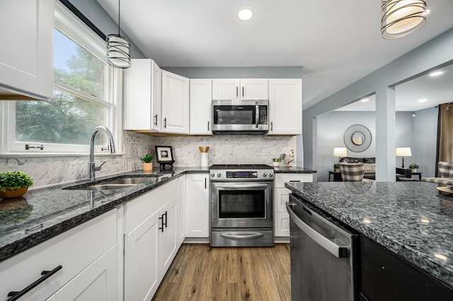 2422 Choctaw Trce, Murfreesboro, TN 37129 - kitchen featuring appliances with stainless steel finishes, white cabinetry, decorative backsplash, dark stone counters, and dark wood-style floors