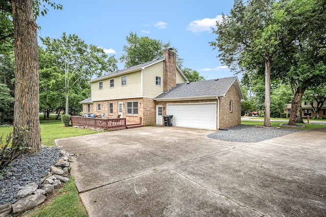 2422 Choctaw Trce, Murfreesboro, TN 37129 - view of side of home with brick siding, a garage, a wooden deck, concrete driveway, and a yard