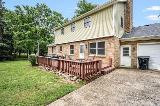 2422 Choctaw Trce, Murfreesboro, TN 37129 - back of property featuring a lawn, brick siding, a wooden deck, a chimney, and driveway