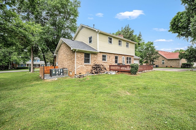 2422 Choctaw Trce, Murfreesboro, TN 37129 - back of property with brick siding, a wooden deck, a yard, and a chimney