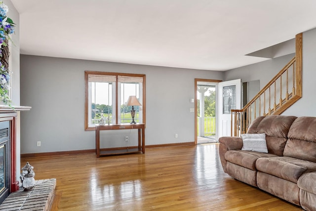 40 Lakeview Trl, Mcminnville, TN 37110 - living area with a glass covered fireplace, light wood finished floors, and stairs
