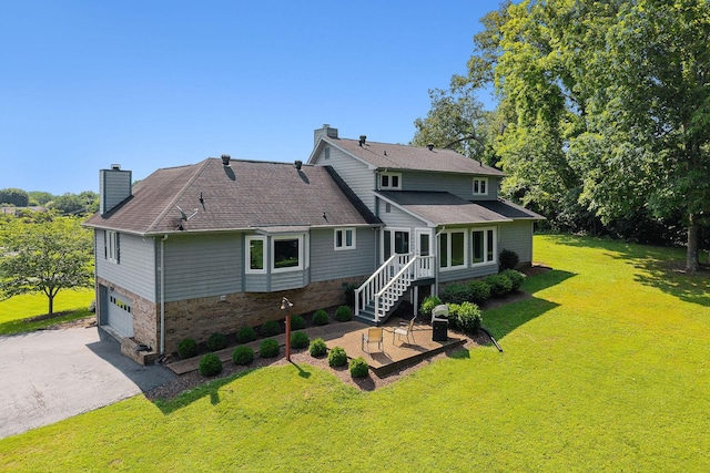 40 Lakeview Trl, Mcminnville, TN 37110 - back of house featuring a chimney, a garage, a lawn, driveway, and a patio area