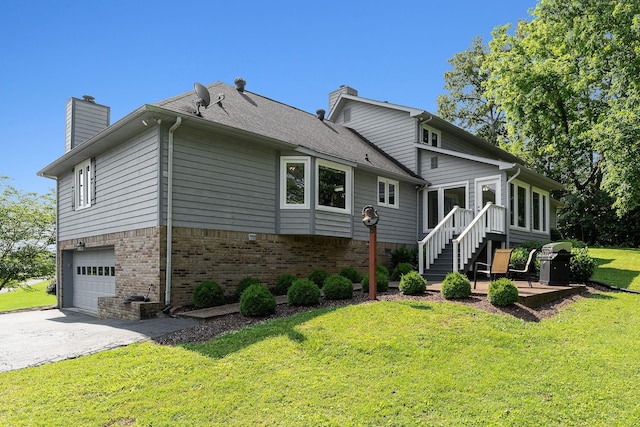 40 Lakeview Trl, Mcminnville, TN 37110 - back of house featuring brick siding, a chimney, an attached garage, a yard, and asphalt driveway